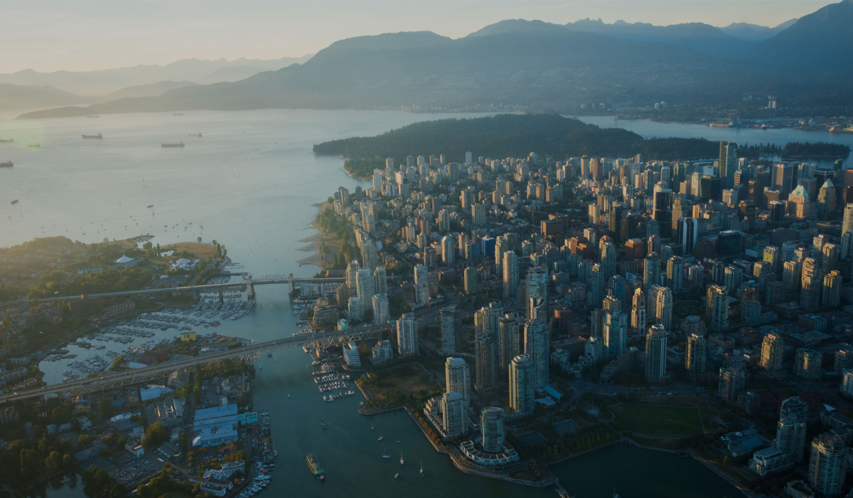 Aerial view of downtown Vancouver, False Creek and surrounding mountains